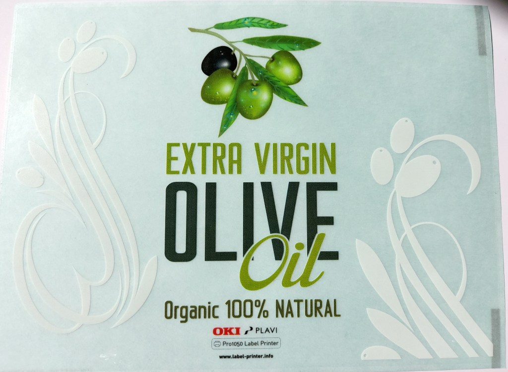 Прозрачен етикет с бели и цветни елементи, предназначен за зехтин